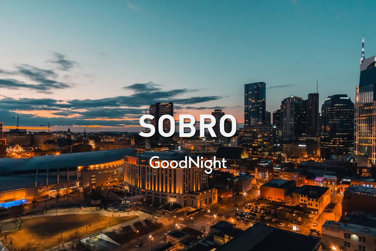 This view highlights the vibrant Nashville city skyline at sunset, with building lights and active street scenes capturing the city’s lively nightlife and energy. The image suggests easy access to downtown events and the excitement of Broadway just a short drive away.
